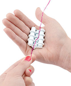 Hand holding the wire straightener and wire